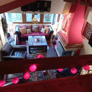 a living room with a couch and a table at CHALET LE BLANC in Arachova