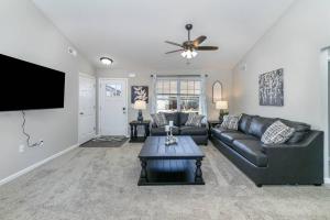 a living room with a couch and a flat screen tv at Brand NEW home among the Nook in Hamilton, Ohio in Hamilton