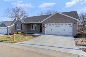 a house with a driveway and a garage at Brand NEW home among the Nook in Hamilton, Ohio in Hamilton