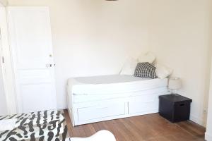 a white bed in a white room with a lamp at Luxurious Apartment Near Parc André Citröen in Paris