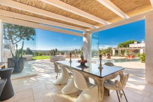 an outdoor dining room with a table and chairs at Ca` della Roccia by Perle di Puglia in Ostuni