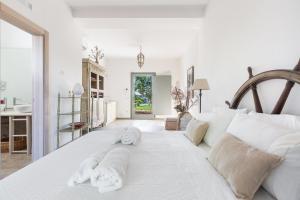 a white bedroom with towels on a bed at Ca` della Roccia by Perle di Puglia in Ostuni +45 photos