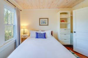 a bedroom with a white bed and a window at Idyllic Blue Ridge Mountain Home on 26-Acre Farm in Roan Mountain