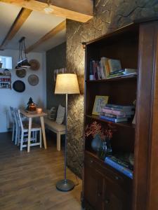 a living room with a book shelf and a table at Apartament Czar-nów in Kamienna Góra