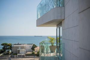 a view of the ocean from the balcony of a building at EVOLUTION Cascais-Estoril Hotel in Estoril