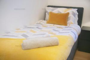 a bed with a towel laying on top of it at Riverside Drive Apartment - Grampian Lettings Ltd in Aberdeen