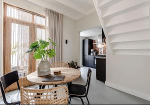 a kitchen and dining room with a table and chairs at Beach House Alexy Zandvoort in Zandvoort