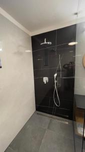 a bathroom with a shower with a hose at Penzión Holub in Banská Bystrica
