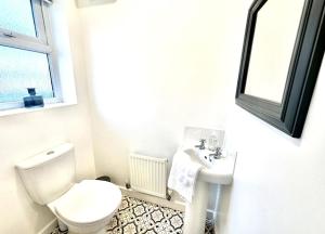 a white bathroom with a toilet and a sink at Riverside View by Blue Skies Stays in Middlesbrough