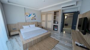 a bedroom with a bed and a flat screen tv at Xen Deluxe Boutique Hotel And Restaurant in Marmaris
