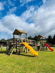 a playground with two slides and a play structure at Cabañas Rimü - Cabaña para 2 personas in Futrono