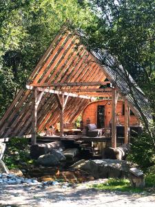 a wooden pavilion in the middle of a forest at GORSKA OSADA Lovely Chalets Zakopane in Poronin