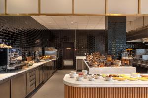 a large kitchen with a bunch of food on counters at EVOLUTION Cascais-Estoril Hotel in Estoril