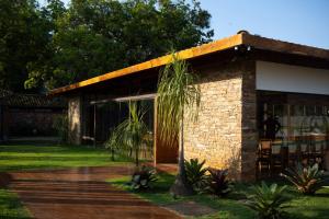 a house with a palm tree in front of it at Tiradentes Boutique Hotel in Tiradentes +21 photos