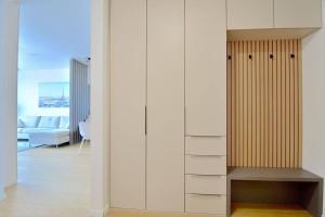 a room with a white wall with a closet at Downtown Charm with free parking spot in Bratislava