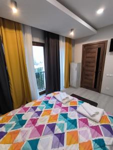 a colorful quilt on a bed in a bedroom at guest house Calma in Telavi +41 photos