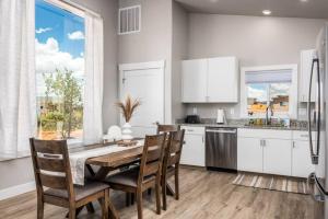 a kitchen with a table and chairs and a large window at High Desert luxury with views for families in Kanab