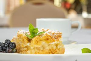 a piece of cake with blueberries on a white plate at Pałac Siemczyno in Siemczyno