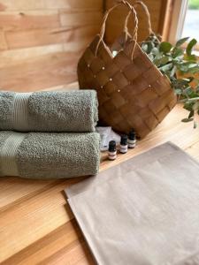 a pile of towels on a wooden floor with a purse at Grigliata Motel and Pool in Glevakha