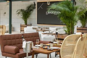 a room with tables and chairs and a projection screen at EVOLUTION Cascais-Estoril Hotel in Estoril