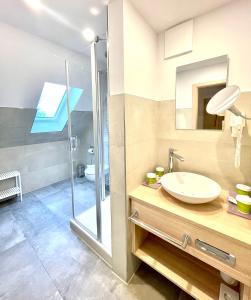a bathroom with a sink and a shower at Ferienhotel Alter Bahnhof garni in Prerow +78 photos