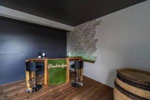 a bar in a room with two stools and a barrel at Maison de vacances à Pordic - proche de la mer in Pordic +11 photos