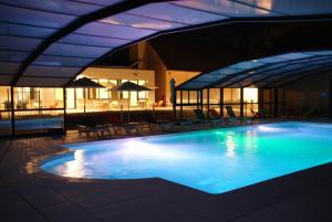 a swimming pool in a building with a lit up at VVF Amboise Les Châteaux de la Loire in Amboise