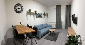 a living room with a blue couch and a table at BK Apartments in Lörrach