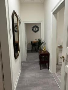 a hallway with a mirror and a table at BK Apartments in Lörrach