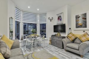 a living room with two couches and a table at Tudor House Holidays - The Apartment for 2 people in Scarborough