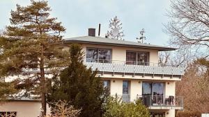 een groot wit huis met een balkon. bij Haus Am Strand in Juliusruh