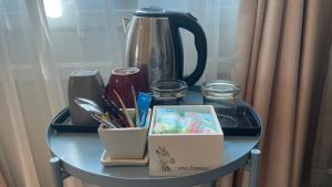 a table with a tea pot and a box on it at Vermont Khao Yai Resort in Ban Na Sok