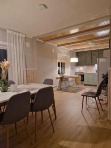a kitchen and dining room with a table and chairs at Apartment close to city center in Tromsø +33 photos