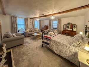 a bedroom with a bed and a living room at Moulsham House in Stoke Ferry