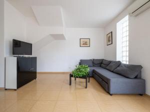 - un salon avec un canapé et une télévision dans l'établissement CASA FIORI, à Cagliari