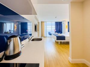 a hotel room with a kitchen and a bed and a bathroom at ORBI CITY Beautiful Luxurios Panoramic View on batumi in Batumi