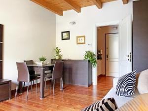 a dining room and kitchen with a table and chairs at Balcony On The Lake - Free Parking, Lake view in Laglio