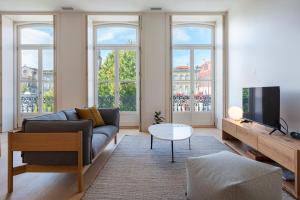 a living room with a couch and a tv at Mouzinho 32 in Porto