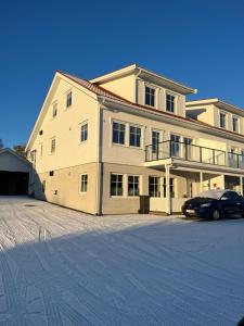 a large house with a car parked in front of it at Villaveien in Sortland