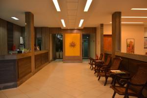 a waiting room with chairs and a yellow wall at Lago Da Palma in Palmas