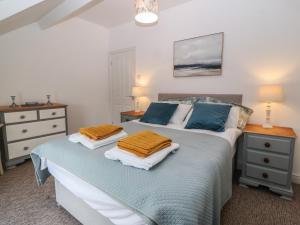 a bedroom with a bed with two pillows on it at The Bell Apartment in Cemaes Bay