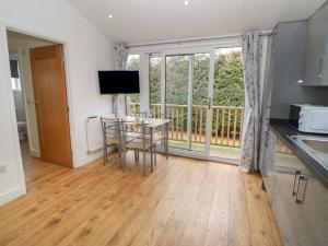 a kitchen and dining room with a table and a window at Ryedale Pod in Yarm