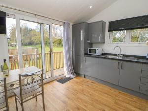 a kitchen with stainless steel appliances and a table at Levendale Pod in Yarm