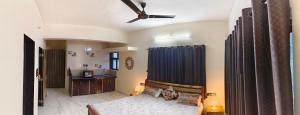 a living room with a couch and a ceiling fan at Bethel Villa in Vaishet