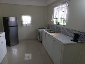 a kitchen with a refrigerator and a stove in it at Cocrico Apartments in Scarborough