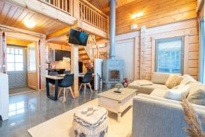 a living room with a couch and a fireplace at Villa Pohjoistuuli - 5+1 henkilölle, Luoteis-Himos Ski-in/out 56m² + 11m² in Jämsä