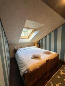 a bedroom with a bed with two pillows on it at la mansarda di Fabio in Bormio