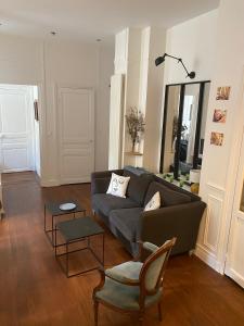 a living room with a couch and a chair at Kak's apartments Paris in Paris