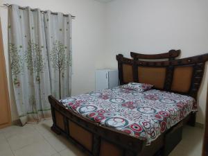a bedroom with a bed and a shower curtain at VACATION HOME STAY AT SHRJAH DUBAI BORDER By mauon tourism in Sharjah