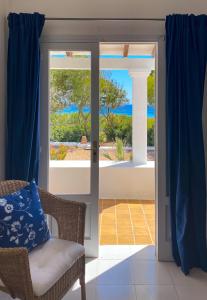 an open door to a patio with a view of the ocean at Voga Mari - Astbury Formentera in Playa Migjorn